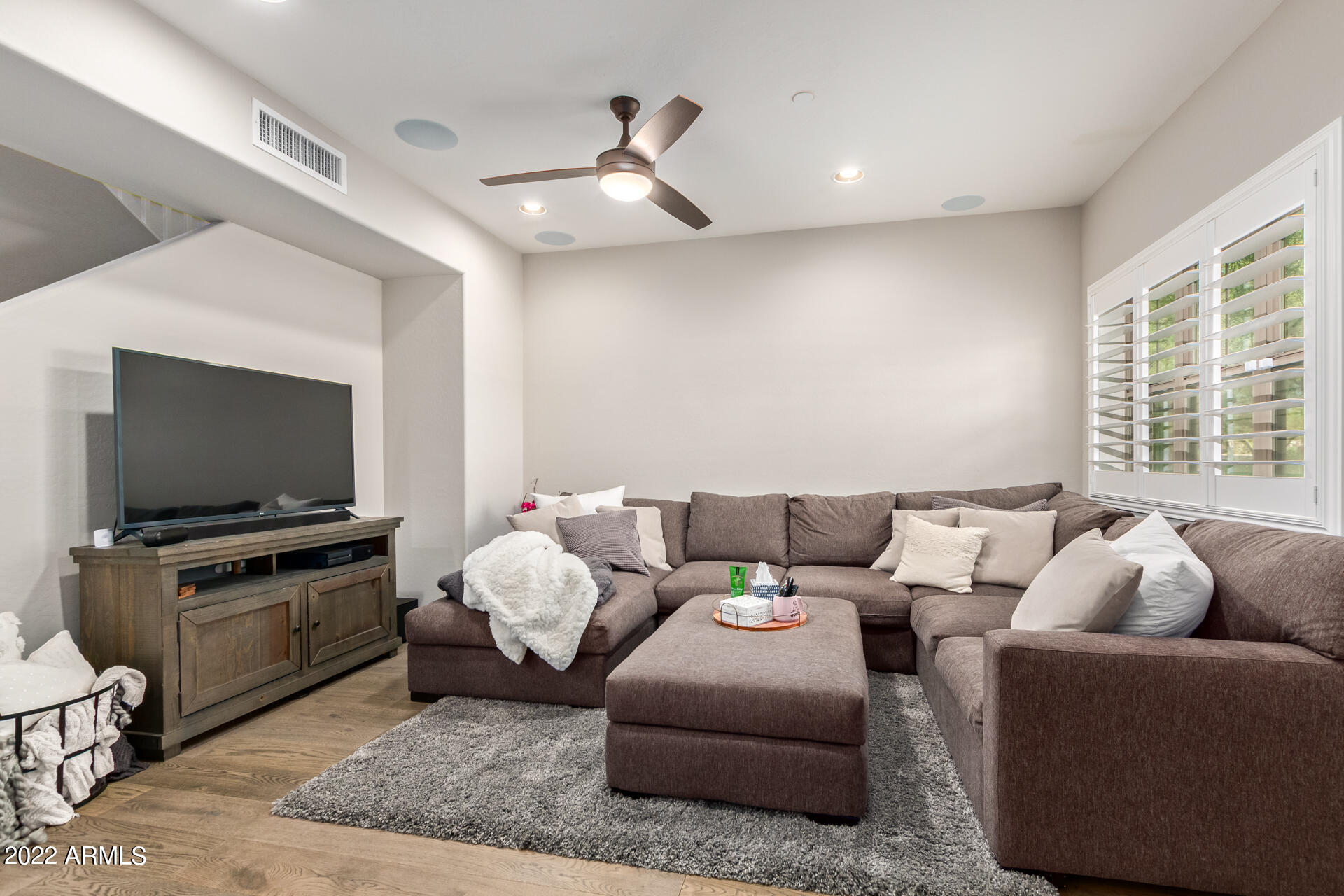 3935 East Rough Rider Road, Unit 1289 Phoenix, AZ 85050 - Photo 29 of 60 a living room with furniture and a flat screen tv