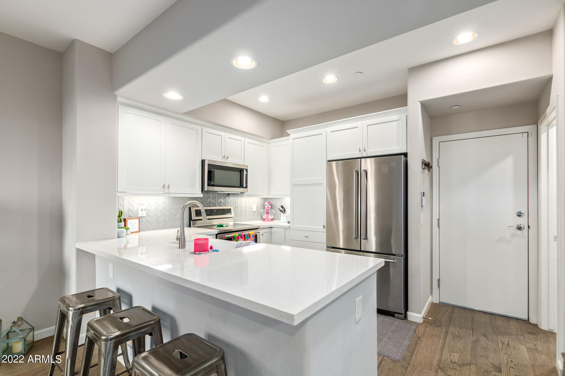 3935 East Rough Rider Road, Unit 1289 Phoenix, AZ 85050 - Photo 35 of 60 a kitchen that has a microwave a refrigerator and a sink