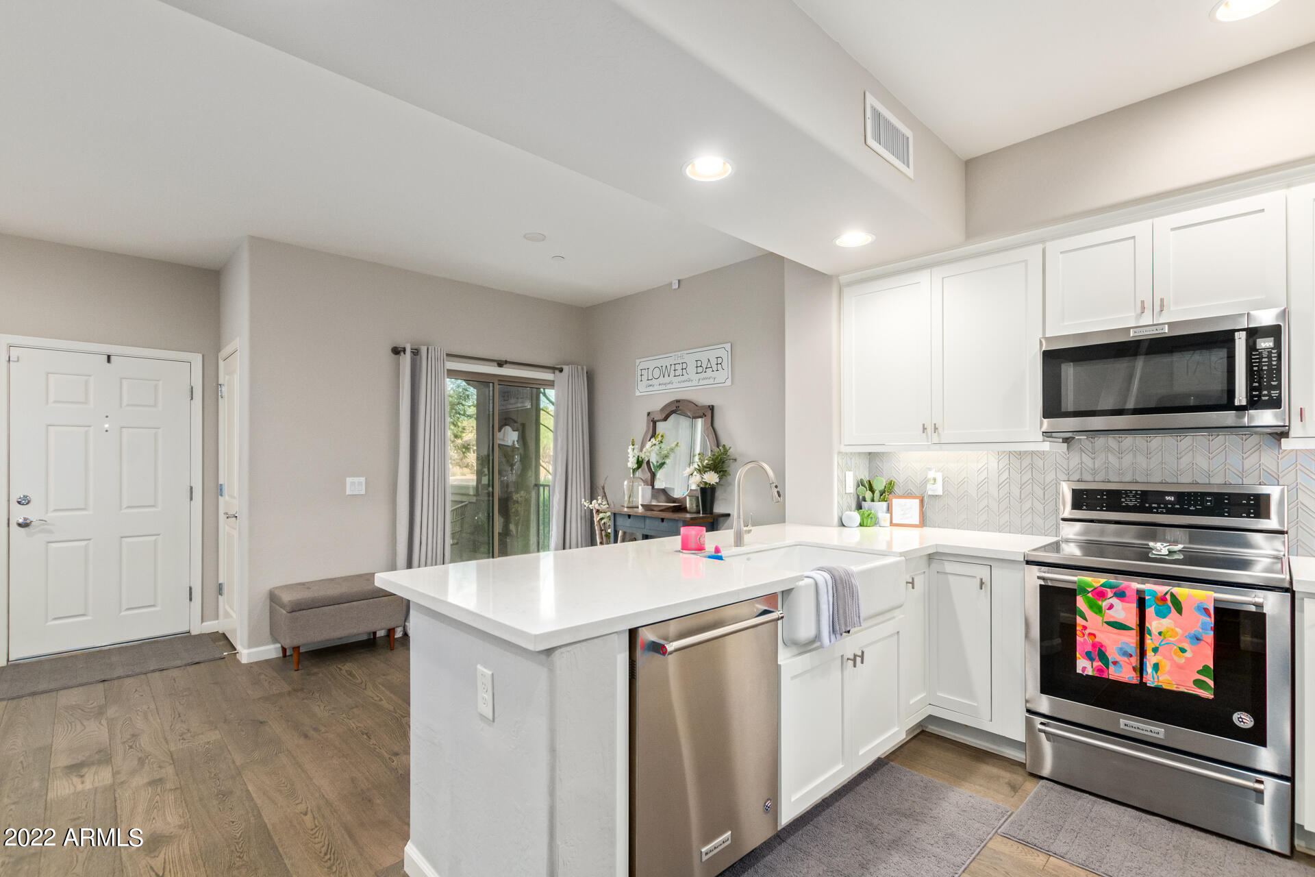 3935 East Rough Rider Road, Unit 1289 Phoenix, AZ 85050 - Photo 37 of 60 a kitchen that has a sink and a stove in it