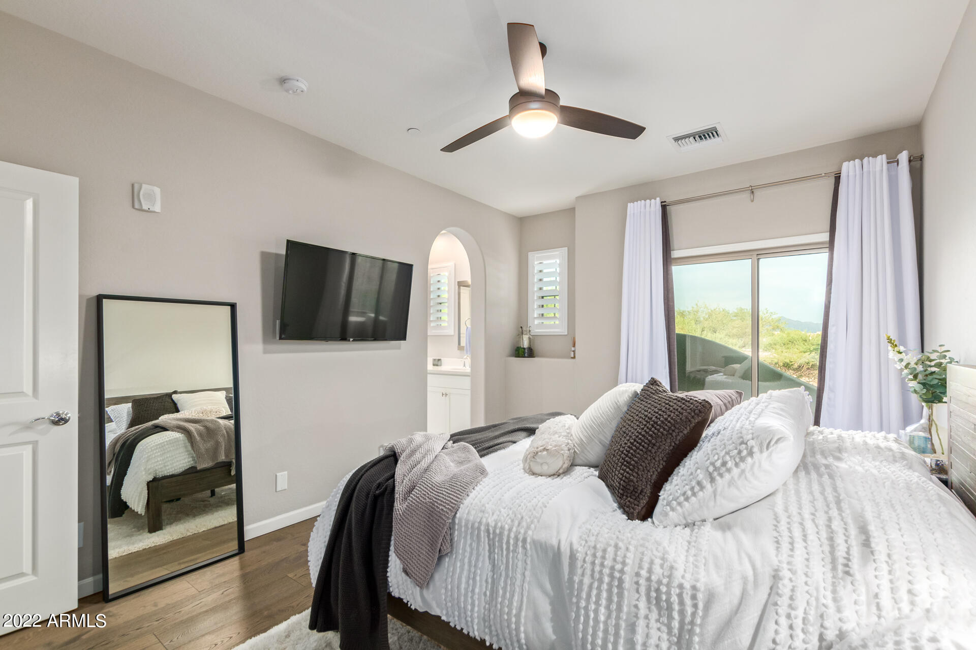 3935 East Rough Rider Road, Unit 1289 Phoenix, AZ 85050 - Photo 40 of 60 a bedroom with a bed and a flat screen tv