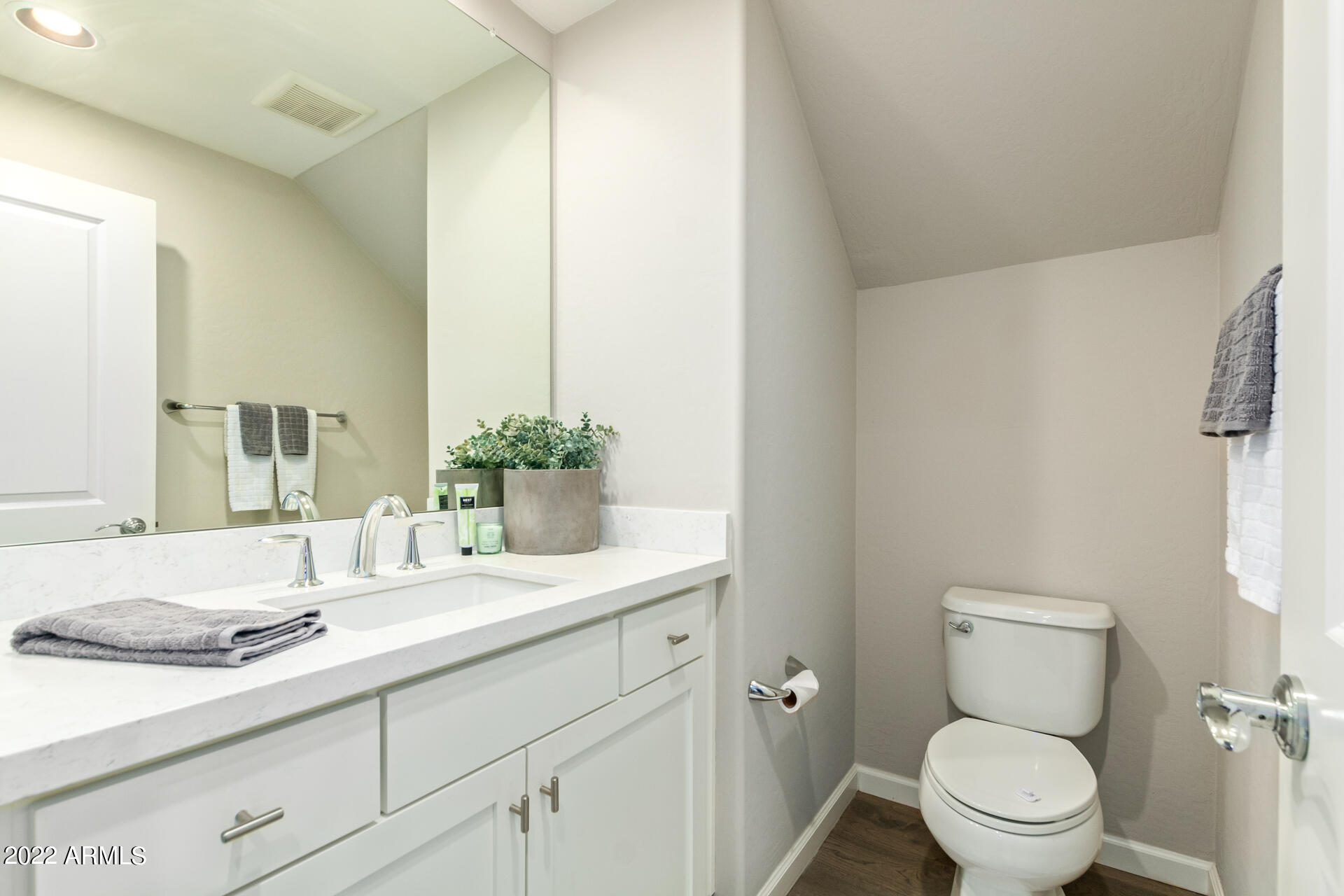 3935 East Rough Rider Road, Unit 1289 Phoenix, AZ 85050 - Photo 9 of 60 a bathroom with a granite countertop toilet sink and mirror