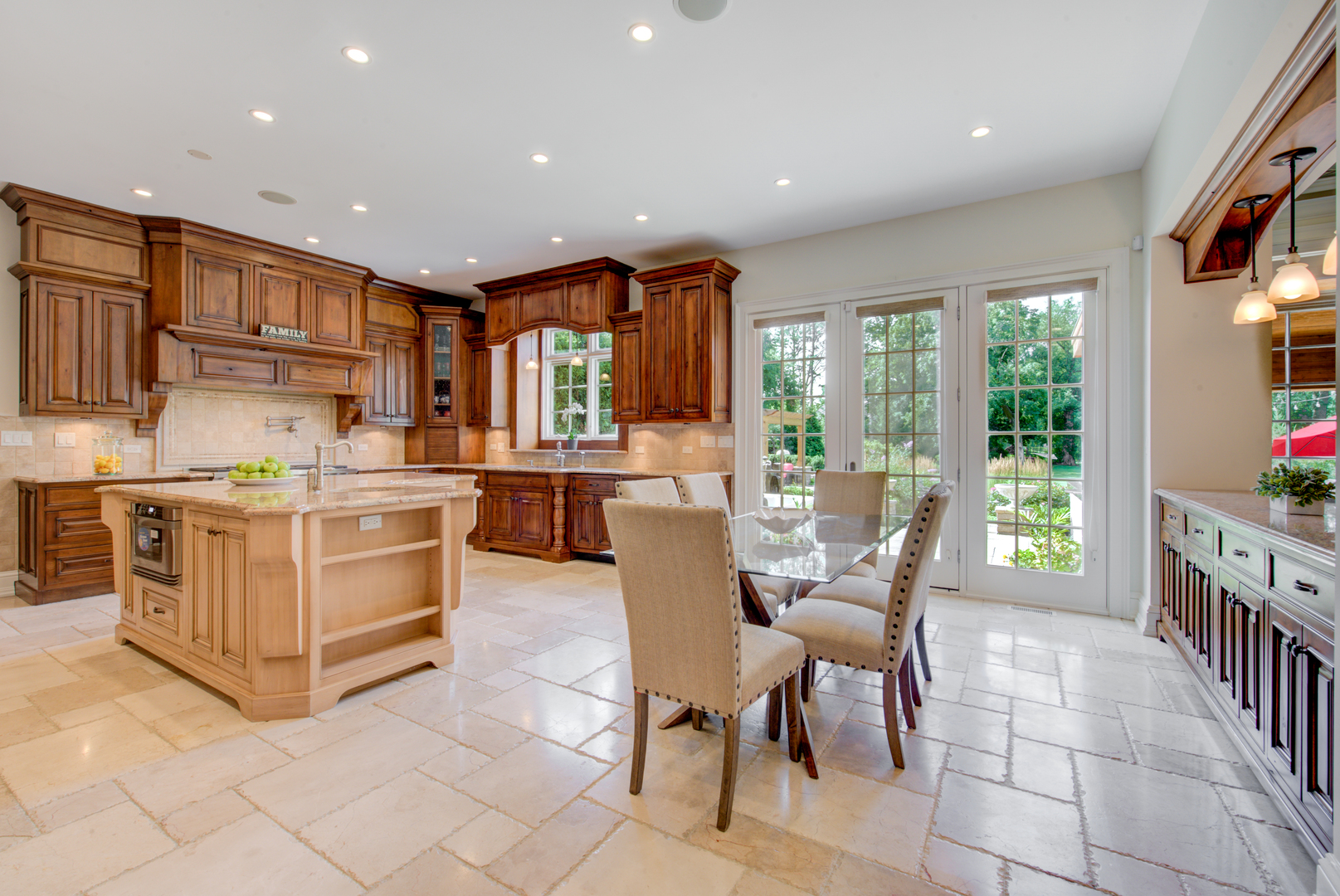 102 Longmeadow Road Winnetka, IL 60093 - Photo 17 of 52 a kitchen with stainless steel appliances kitchen island granite countertop a stove a sink a dining table and chairs