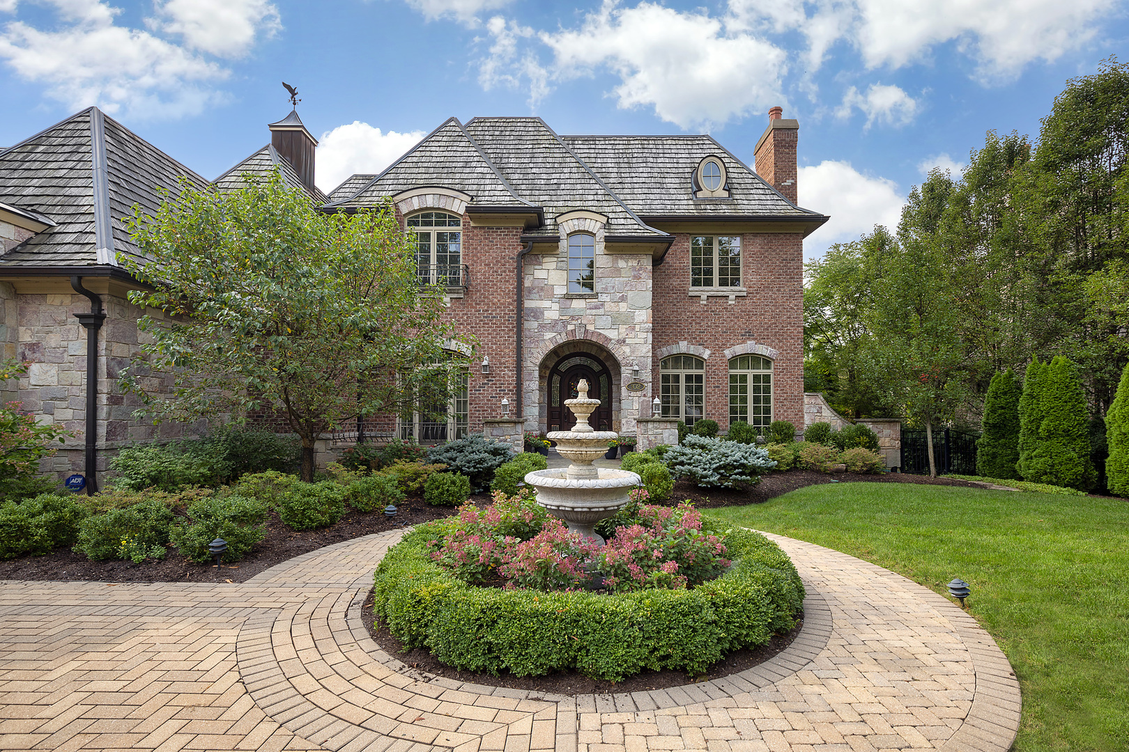 102 Longmeadow Road Winnetka, IL 60093 - Photo 2 of 52 a front view of a house with garden