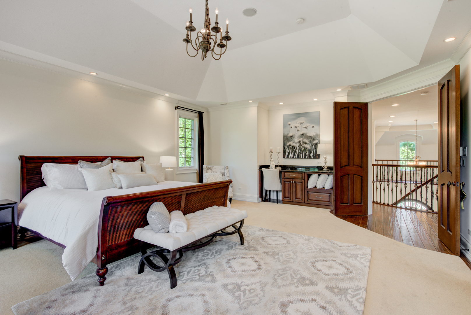 102 Longmeadow Road Winnetka, IL 60093 - Photo 28 of 52 a spacious bedroom with a bed a chandelier and large windows