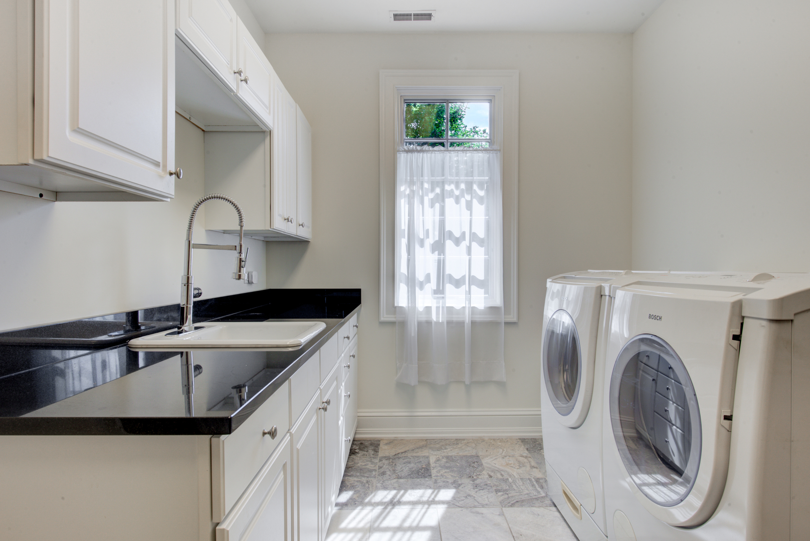 102 Longmeadow Road Winnetka, IL 60093 - Photo 37 of 52 a kitchen with a sink a washer and dryer
