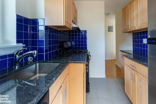 a bathroom with a granite countertop sink a toilet and bathtub