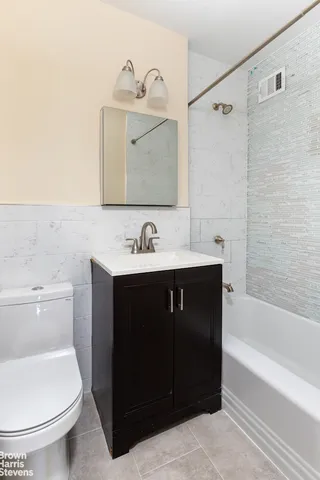 a bathroom with a sink a toilet and bathtub