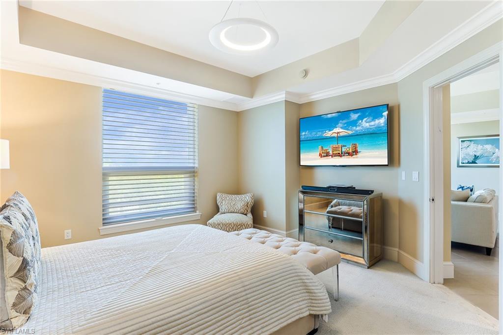 9115 Strada Place, Unit 5414 Naples, FL 34108 - Photo 11 of 26 a bedroom with a bed and a flat screen tv