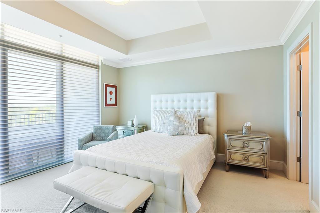 9115 Strada Place, Unit 5414 Naples, FL 34108 - Photo 5 of 26 a bedroom with a bed a mirror and a window