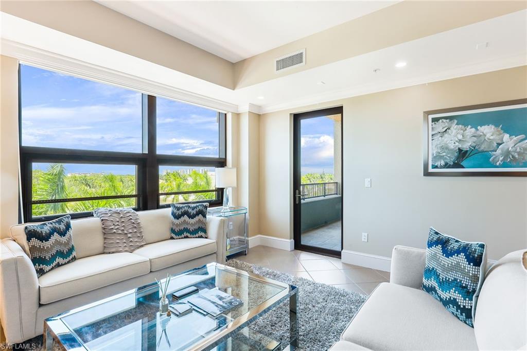 9115 Strada Place, Unit 5414 Naples, FL 34108 - Photo 8 of 26 a living room with furniture and a large window