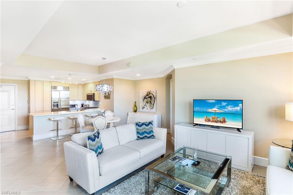 9115 Strada Place, Unit 5414 Naples, FL 34108 - Photo 9 of 26 a living room with furniture and a view of kitchen