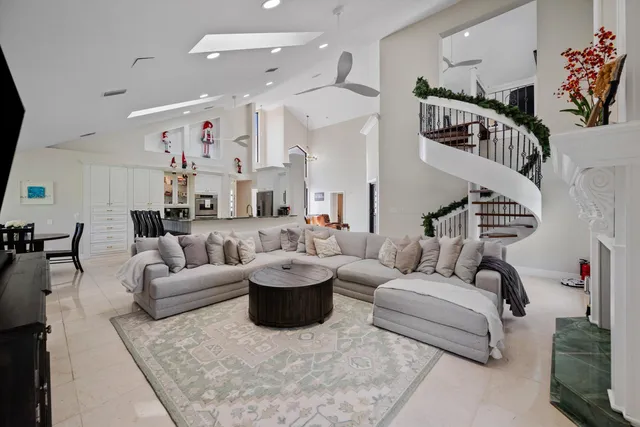 a living room with furniture kitchen view and a flat screen tv