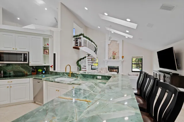 a kitchen with sink refrigerator and microwave