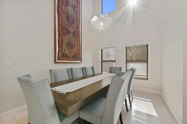 a view of a dining room with furniture and chandelier