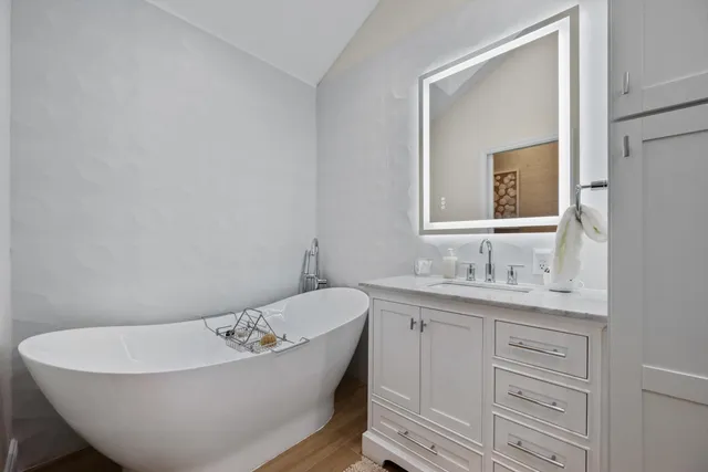 a bathroom with a double vanity sink a mirror and a shower