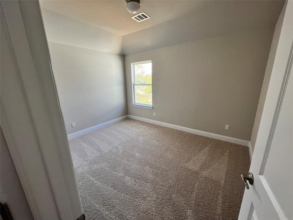 128 Free Stone Drive Georgetown, TX 78628 - Photo 16 of 29 Carpeted room featuring a single window, neutral wall paint, white trim, and a flush-mount ceiling fixture