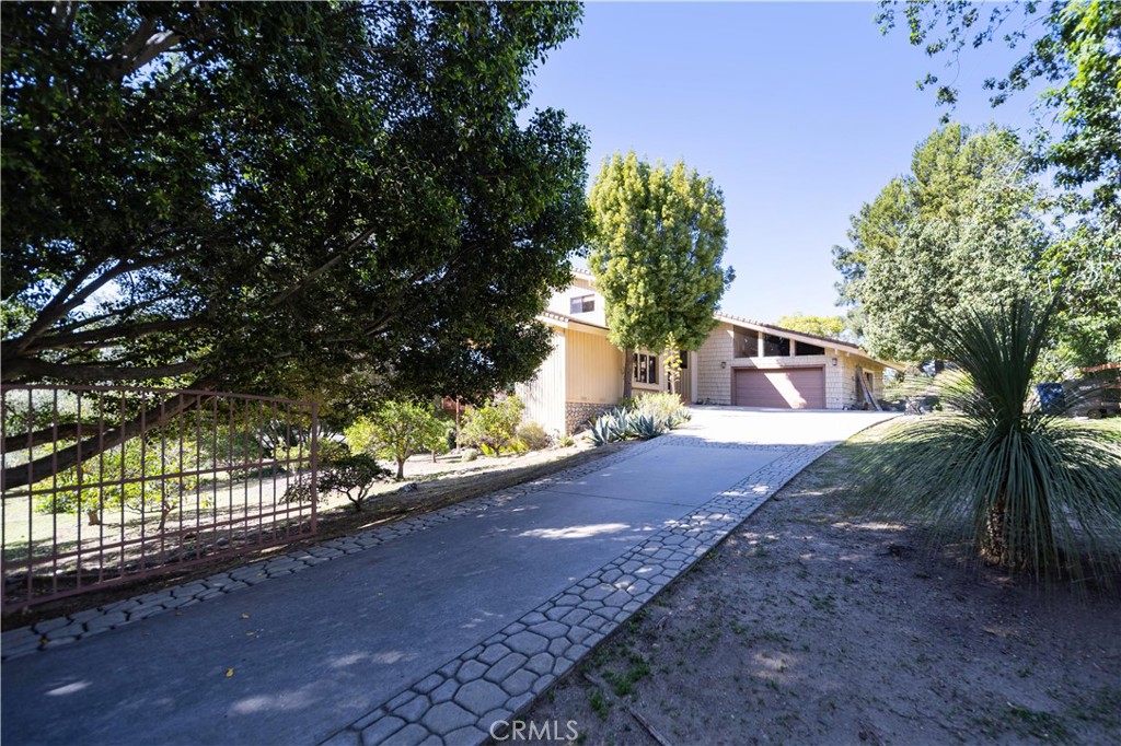 2248 Mil Sorpresas Drive Fallbrook, CA 92028 - Photo 3 of 74 a front view of a house with a yard and tree s