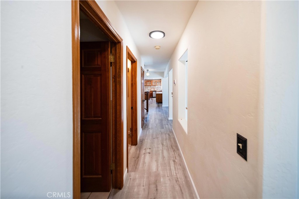2248 Mil Sorpresas Drive Fallbrook, CA 92028 - Photo 51 of 74 a view of a hallway with wooden floor and staircase