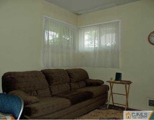 18 Brookville Road Edison, NJ 08817 - Photo 6 of 8 a living room with furniture and a window