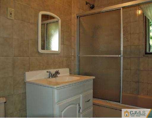 18 Brookville Road Edison, NJ 08817 - Photo 7 of 8 a bathroom with a sink and mirror