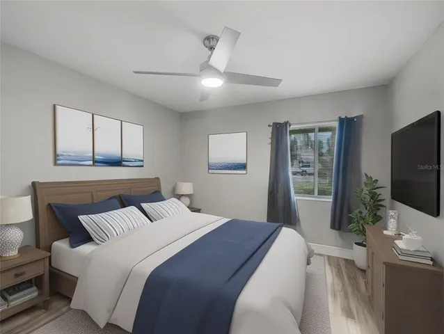 a bedroom with a large bed and a flat screen tv