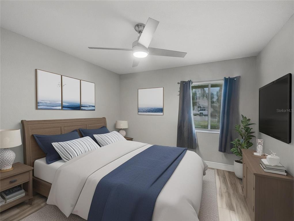 622 Fairways Circle, Unit A Ocala, FL 34472 - Photo 12 of 26 a bedroom with a large bed and a flat screen tv