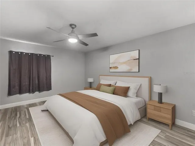 a bedroom with a large bed and a chandelier