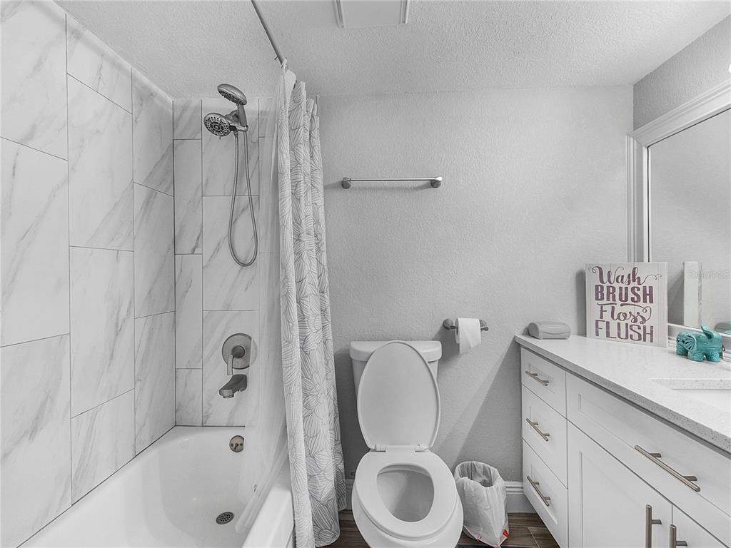 622 Fairways Circle, Unit A Ocala, FL 34472 - Photo 15 of 26 a bathroom with a toilet sink vanity and shower