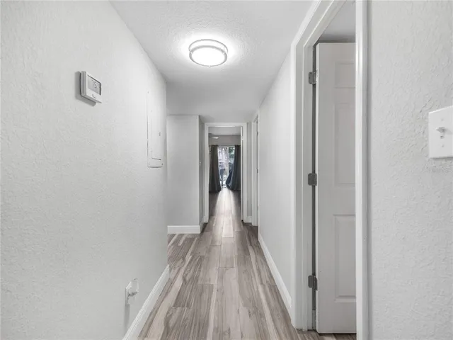 a view of a hallway with wooden floor
