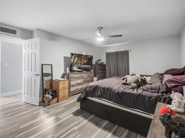 a bed room with a bed and a flat tv screen