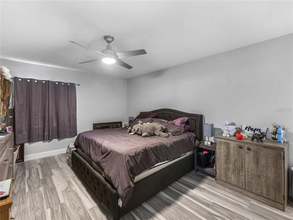 622 Fairways Circle, Unit A Ocala, FL 34472 - Photo 25 of 26 a bedroom with a bed and a chandelier