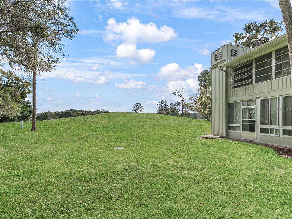 622 Fairways Circle, Unit A Ocala, FL 34472 - Photo 3 of 26 a backyard of a house with lots of green space