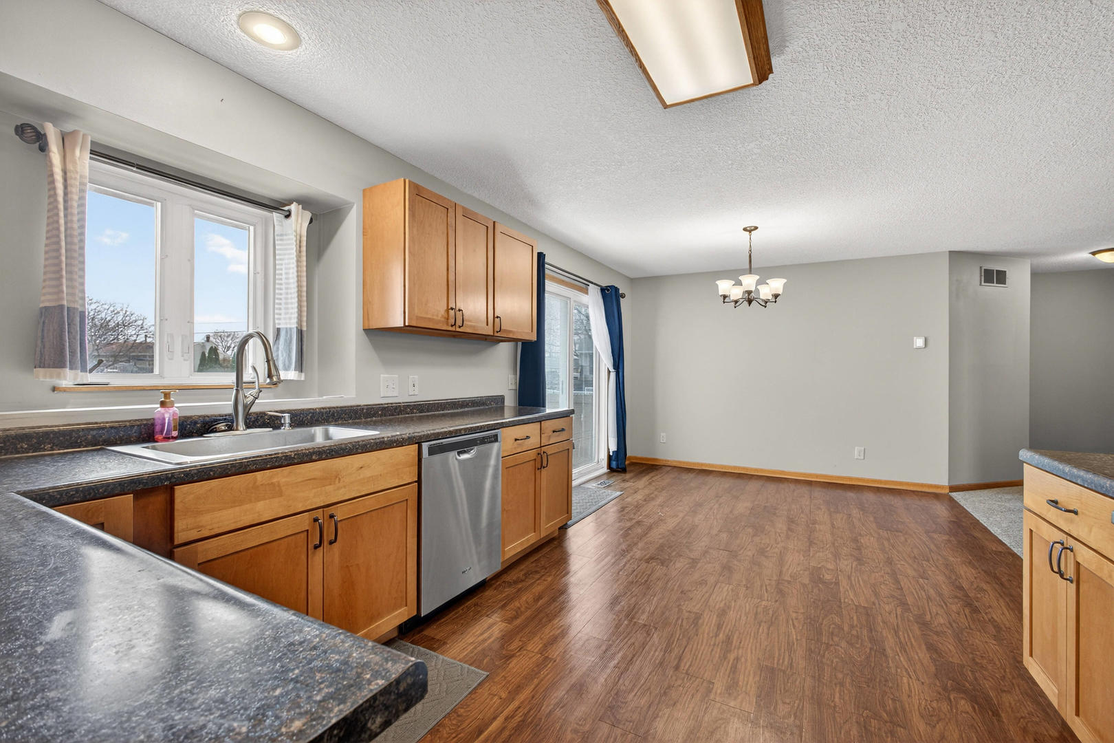 313 Sullivan Drive Colona, IL 61241 - Photo 13 of 41 a view of a kitchen with a sink wooden cabinets and a window