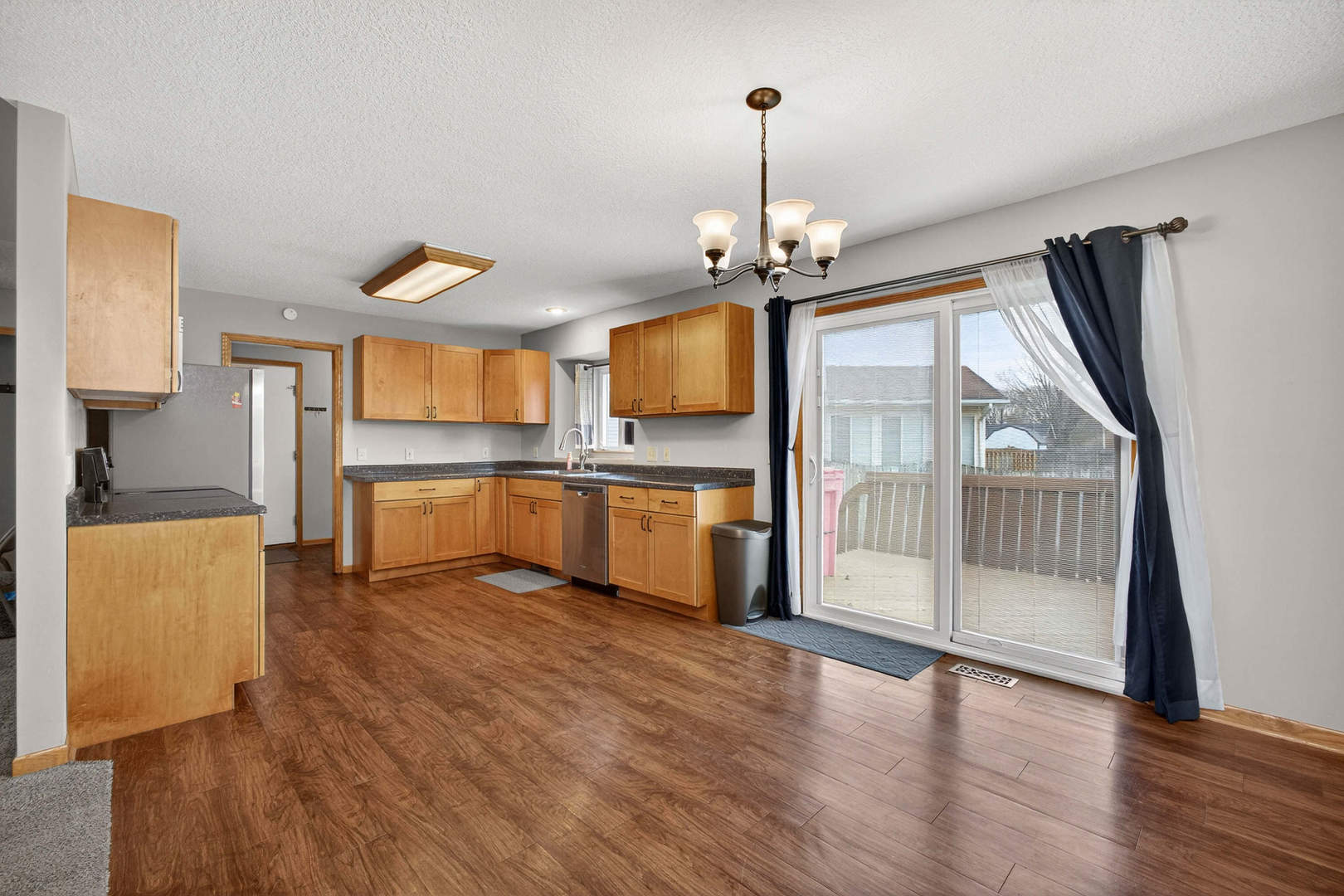 313 Sullivan Drive Colona, IL 61241 - Photo 7 of 41 a view of a kitchen with a sink wooden cabinet and a wooden floor