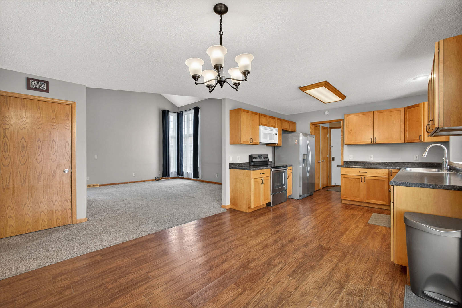 313 Sullivan Drive Colona, IL 61241 - Photo 9 of 41 a view of kitchen with granite countertop stainless steel appliances and wooden floor