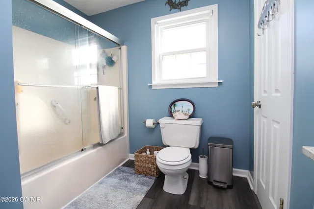 a white toilet sitting next to a bathroom sink and tub