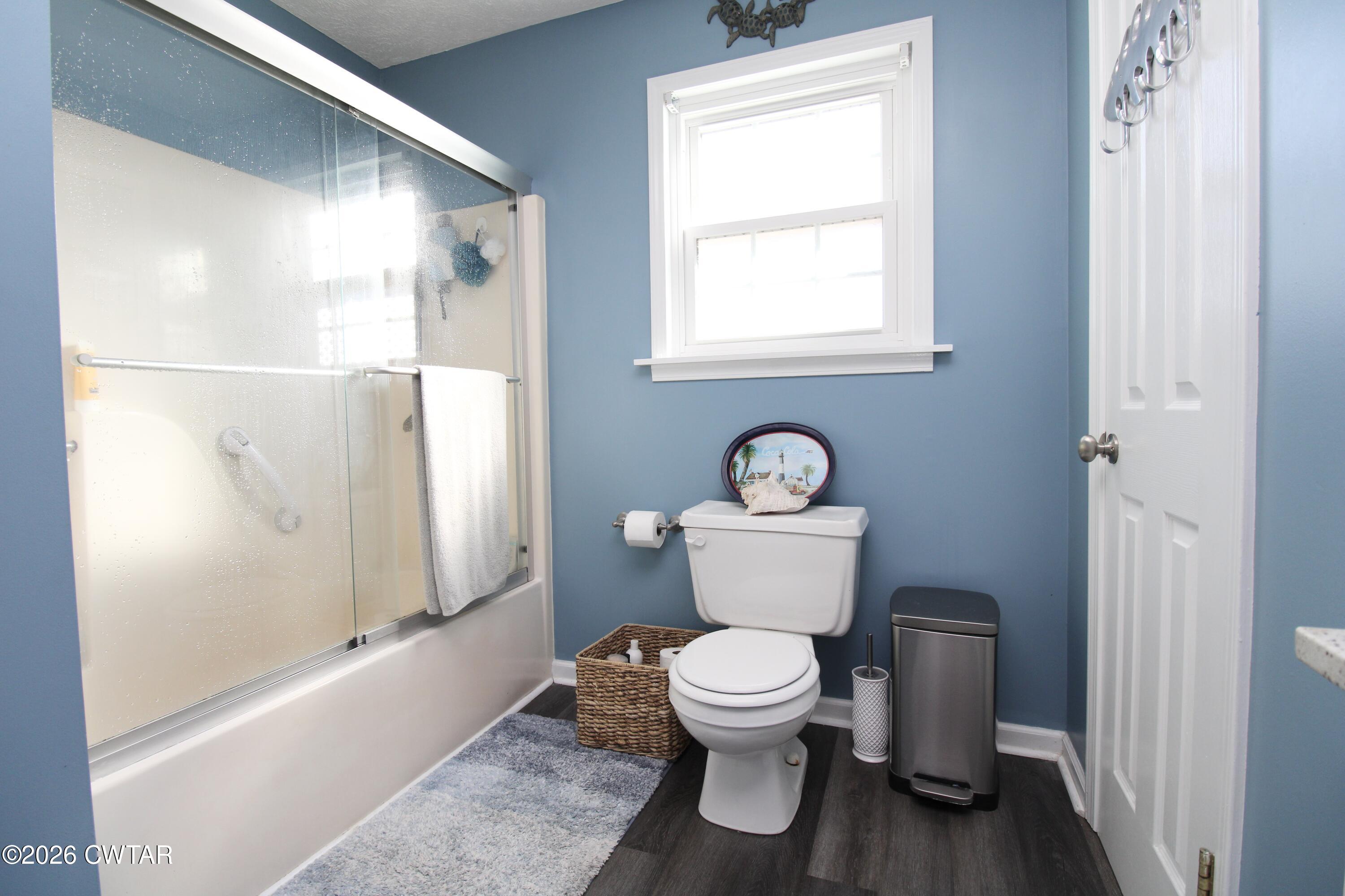 285 Meadowbrook Circle Lexington, TN 38351 - Photo 13 of 26 a white toilet sitting next to a bathroom sink and tub