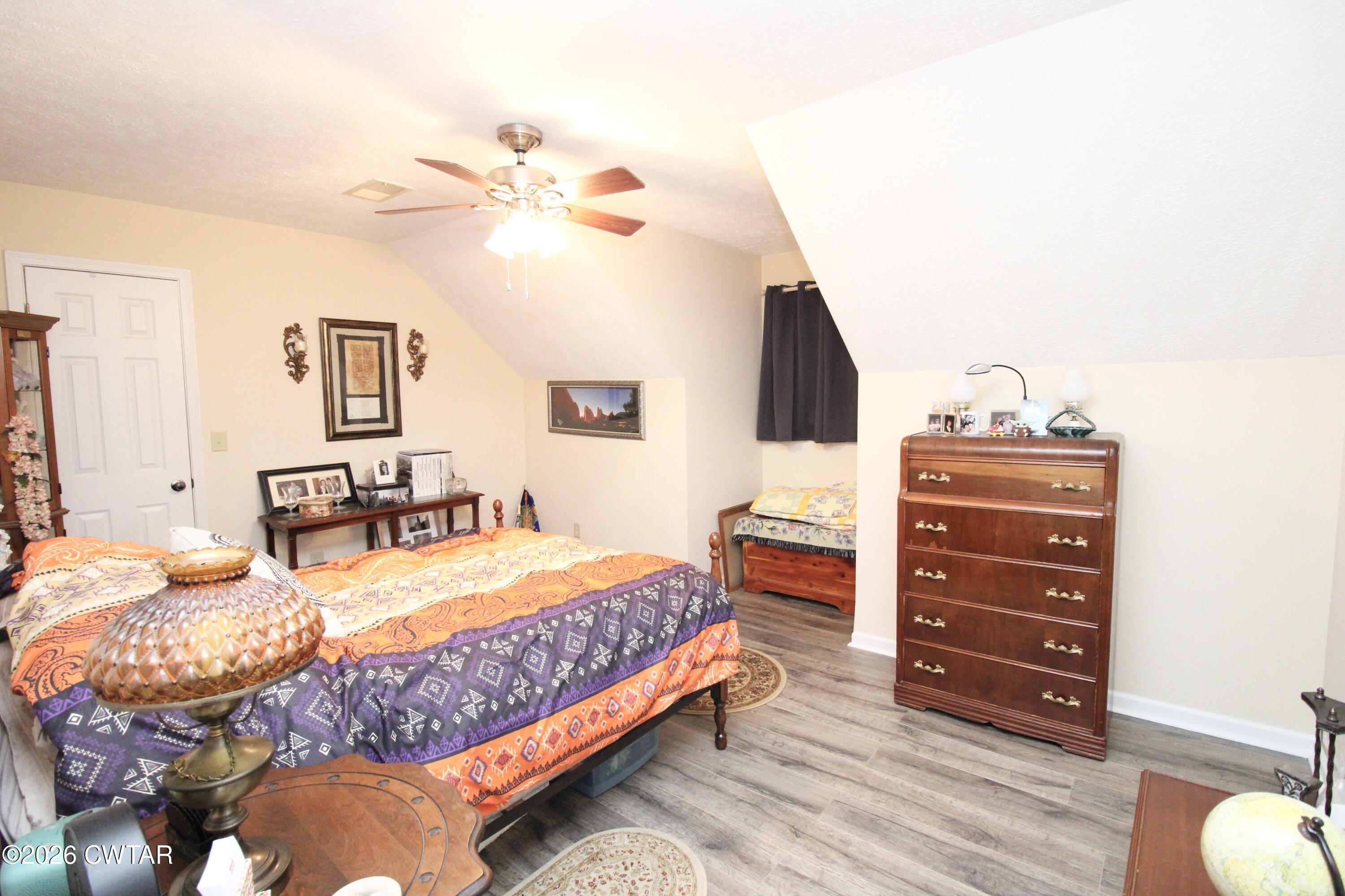 285 Meadowbrook Circle Lexington, TN 38351 - Photo 15 of 26 a bedroom with a bed and wooden floor