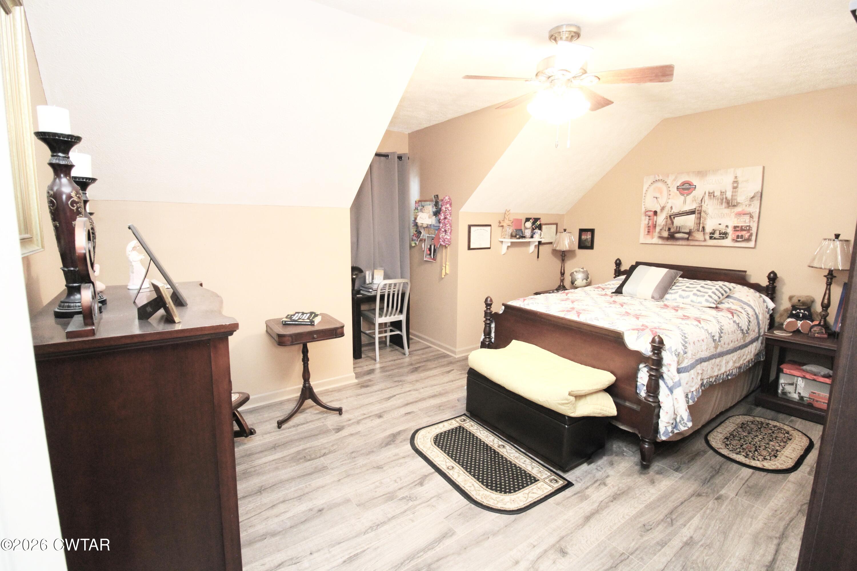 285 Meadowbrook Circle Lexington, TN 38351 - Photo 17 of 26 a bedroom with a bed and wooden floor