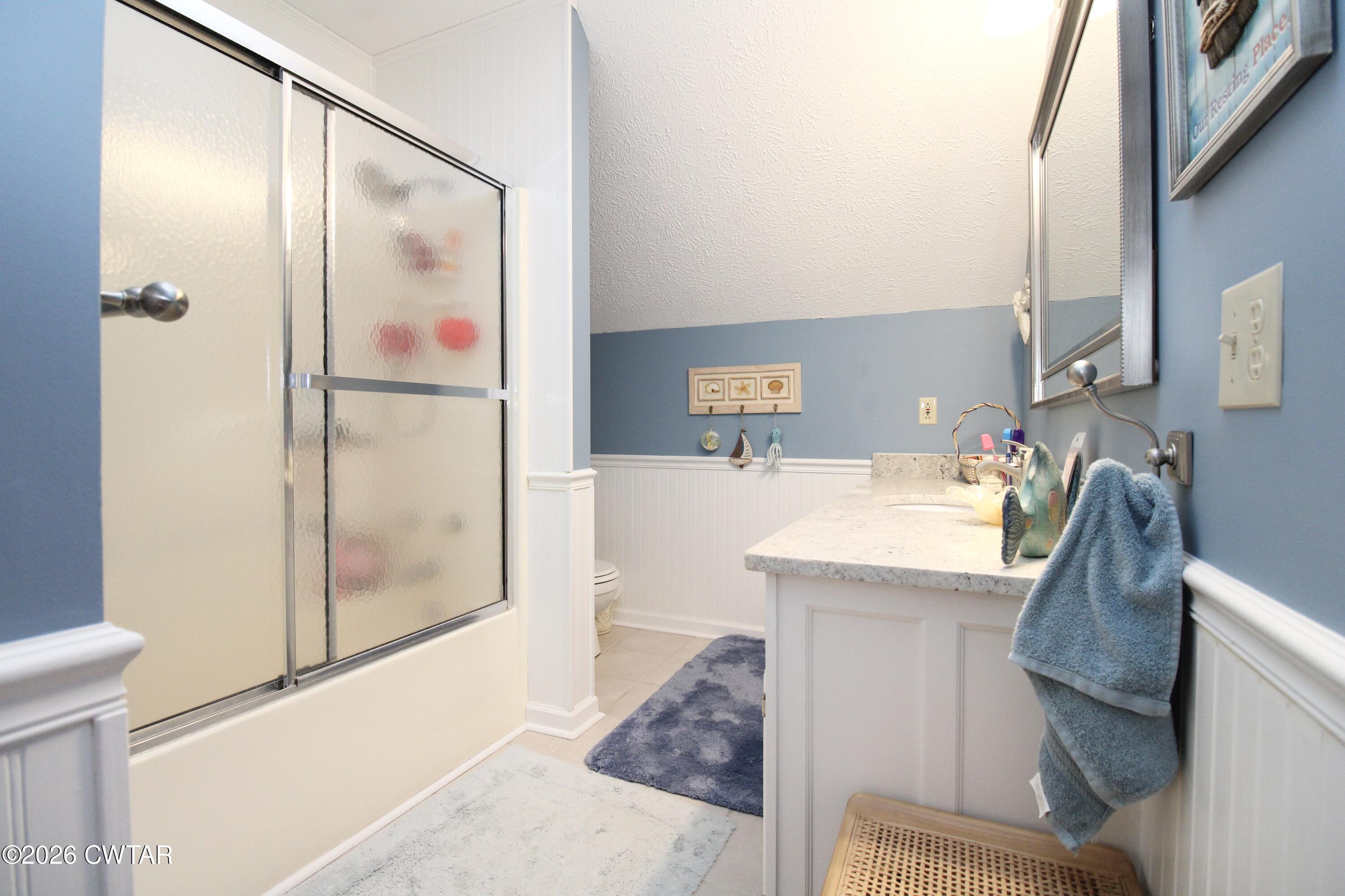 285 Meadowbrook Circle Lexington, TN 38351 - Photo 18 of 26 a bathroom with a granite countertop sink and a mirror