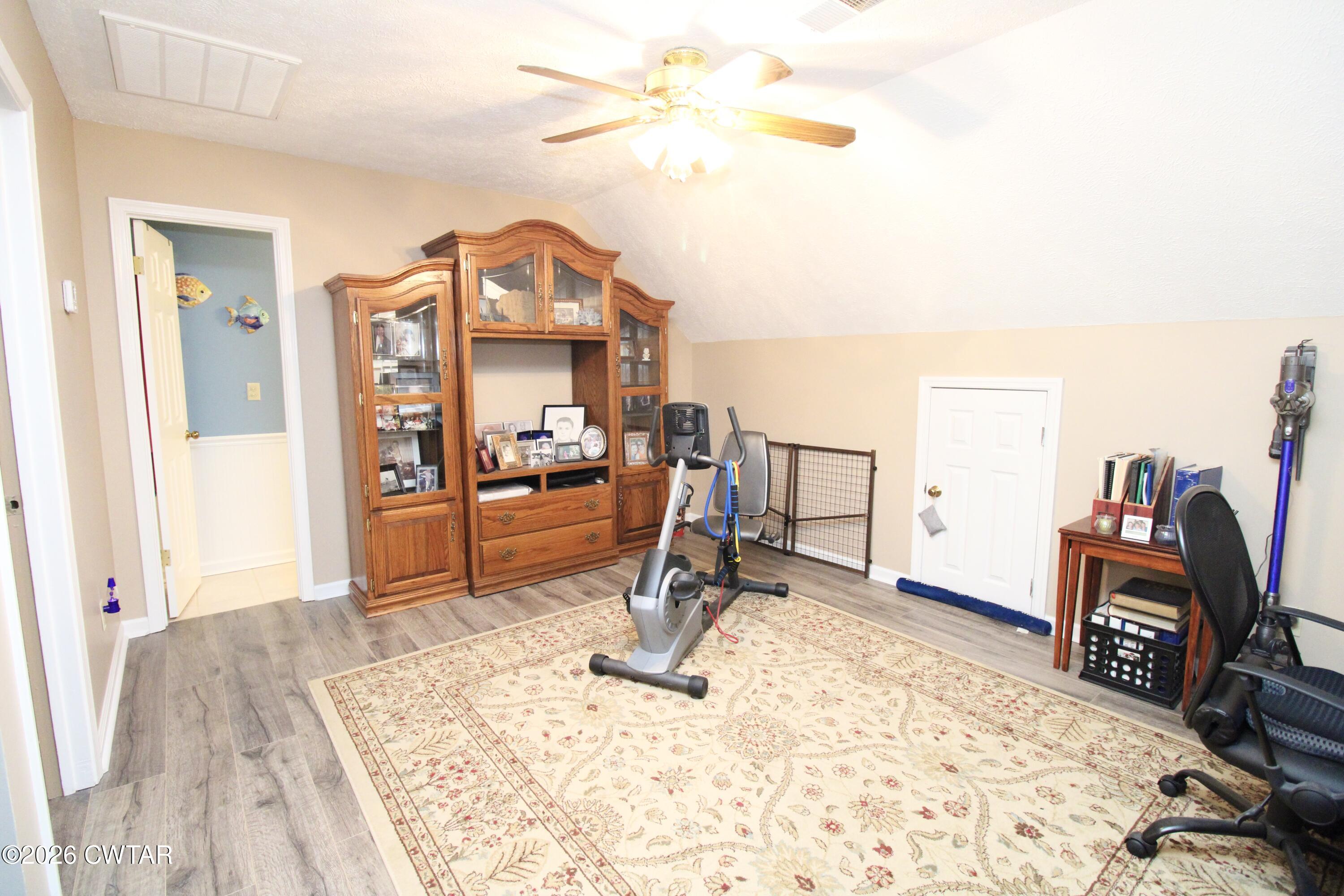 285 Meadowbrook Circle Lexington, TN 38351 - Photo 18 of 26 a bedroom with furniture and a wooden floor