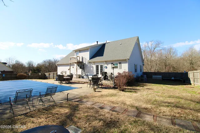 a view of a house with yard and sitting area