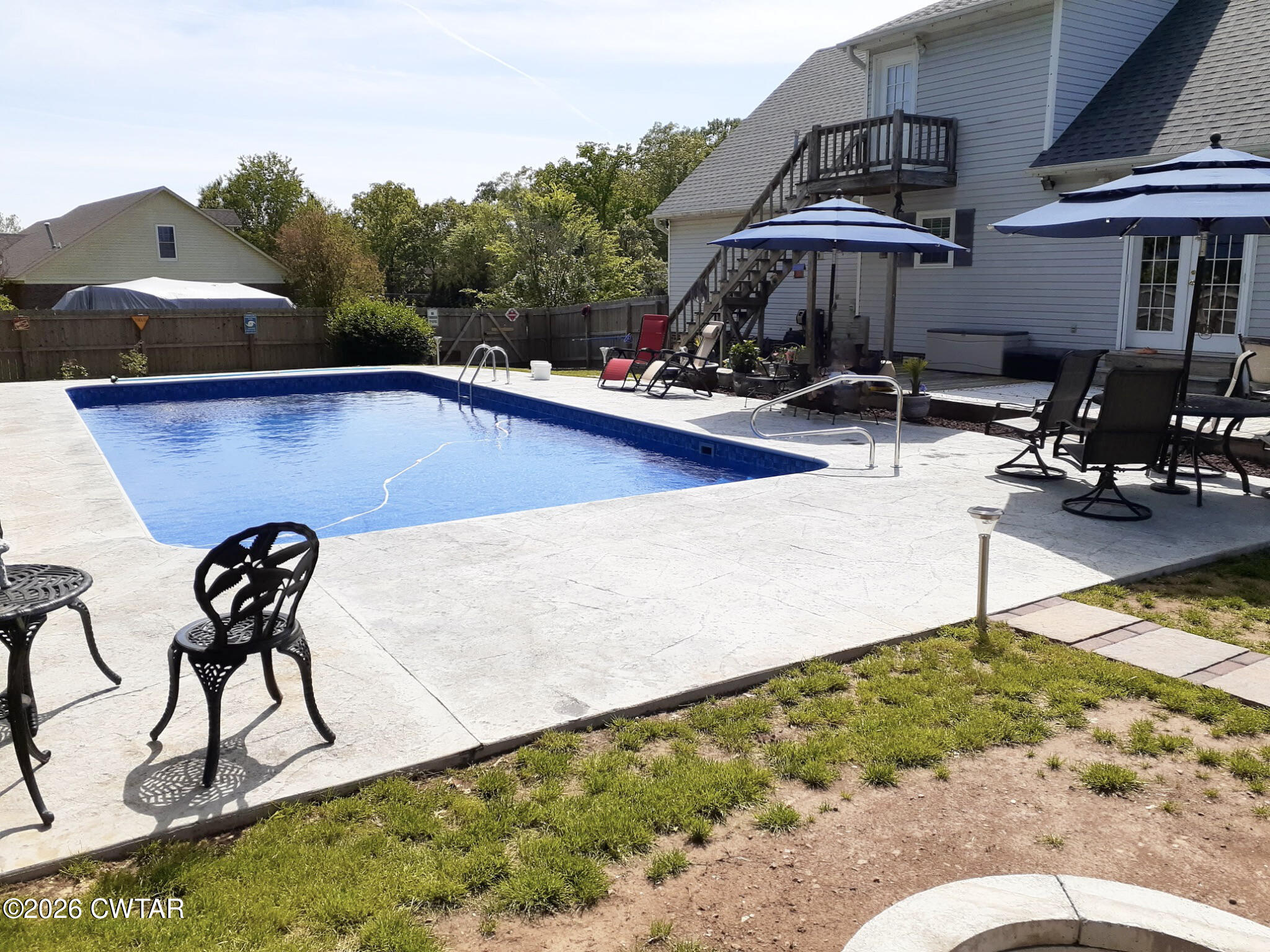 285 Meadowbrook Circle Lexington, TN 38351 - Photo 3 of 26 a view of swimming pool with seating area and trees in the background