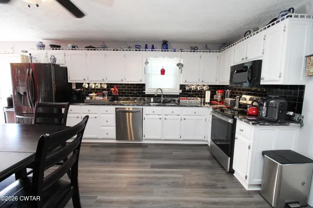 a kitchen with stainless steel appliances a stove a sink dishwasher and a refrigerator