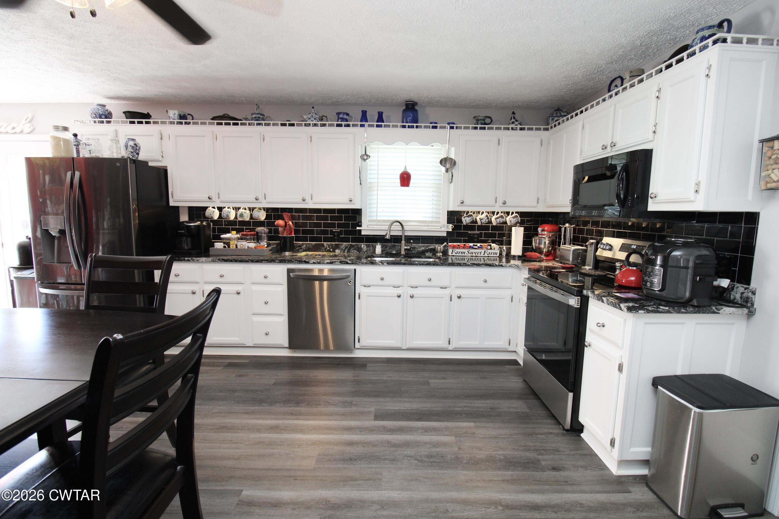 285 Meadowbrook Circle Lexington, TN 38351 - Photo 7 of 26 a kitchen with stainless steel appliances a stove a sink dishwasher and a refrigerator
