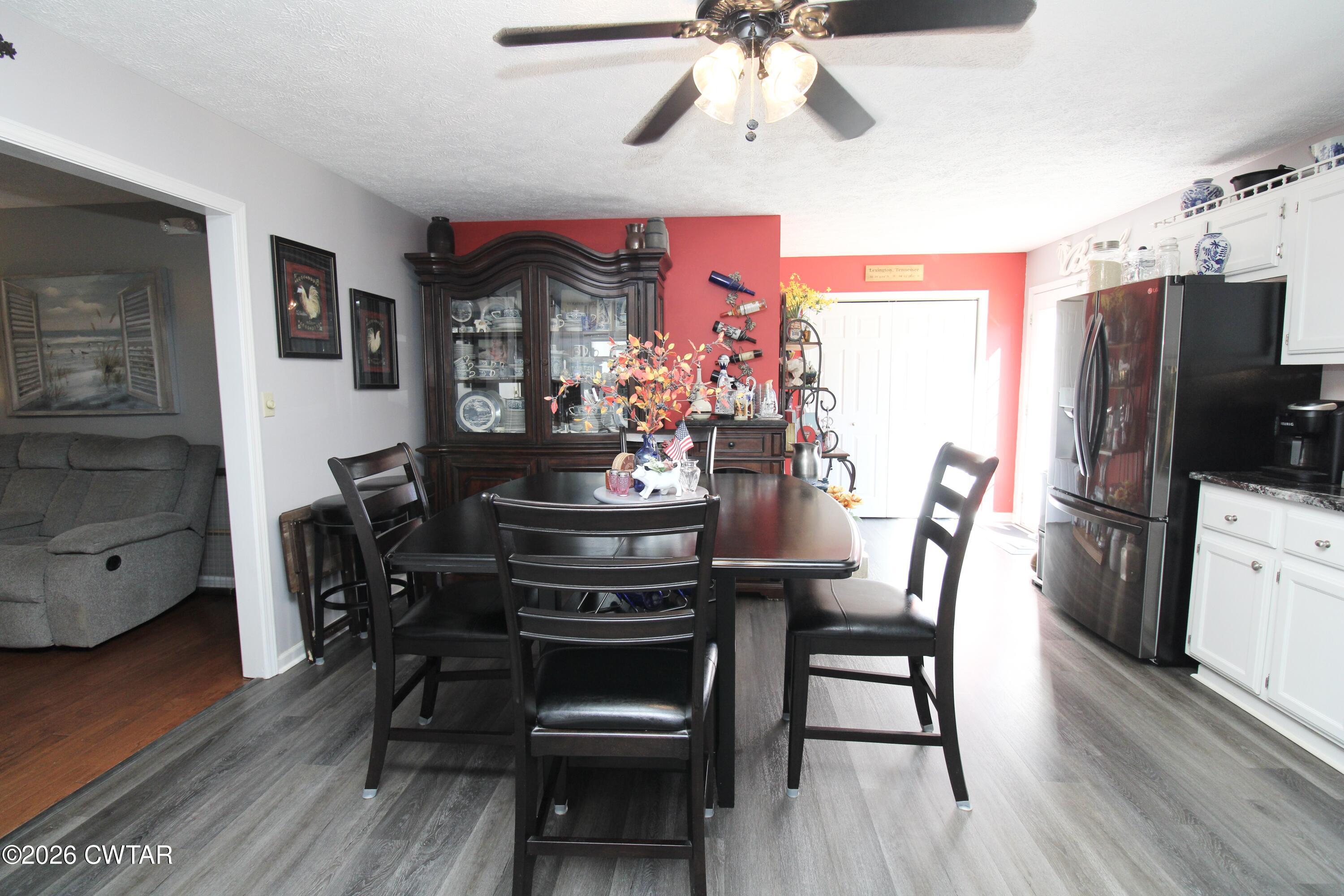 285 Meadowbrook Circle Lexington, TN 38351 - Photo 7 of 26 a view of a dining room with furniture and wooden floor