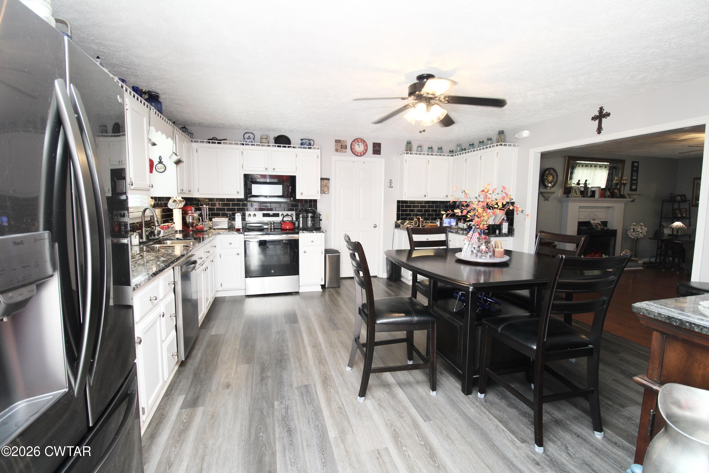 285 Meadowbrook Circle Lexington, TN 38351 - Photo 8 of 26 a kitchen with stainless steel appliances wooden floor and dining table