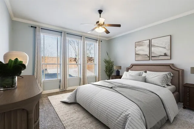 a bedroom with a large bed and a chandelier