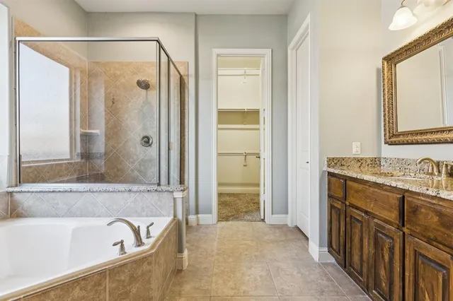 a bathroom with a tub sink and mirror