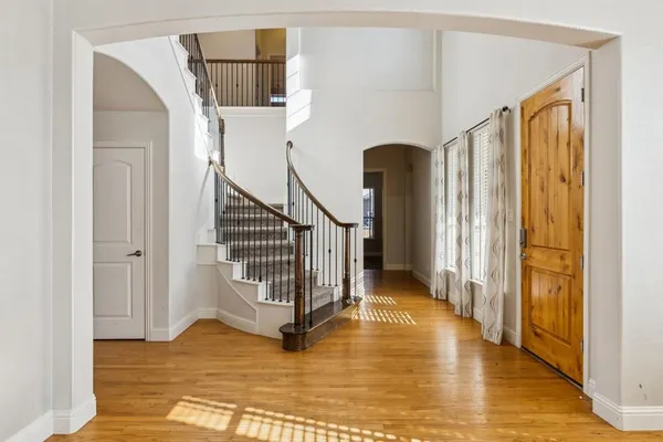 a view of entryway and hall with wooden floor